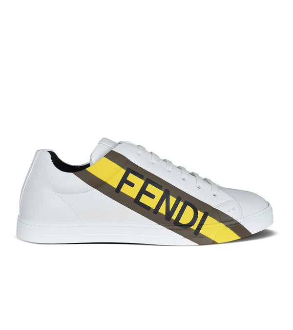 sneakers in white Diagonal stripe with brown and yellow logo.